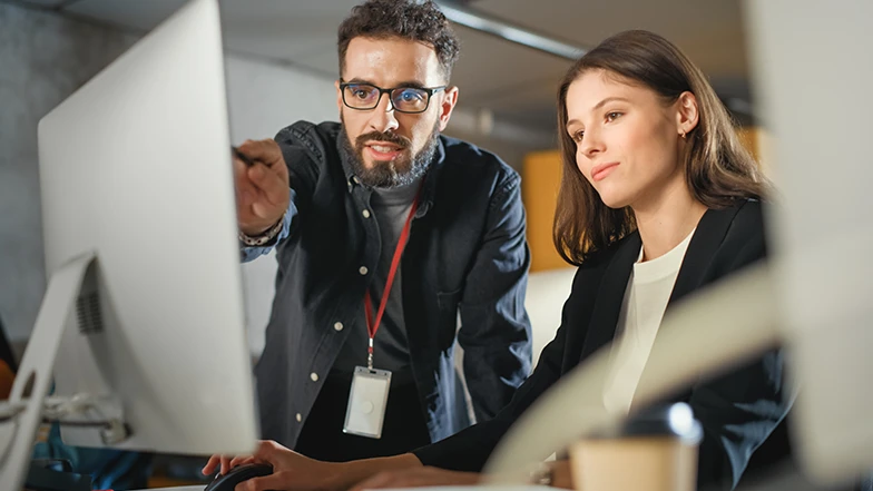 woman and man in front of computer