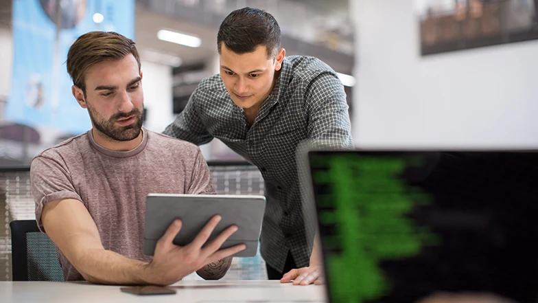 Men looking at tablet