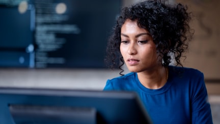Individual looking at a monitor in an office